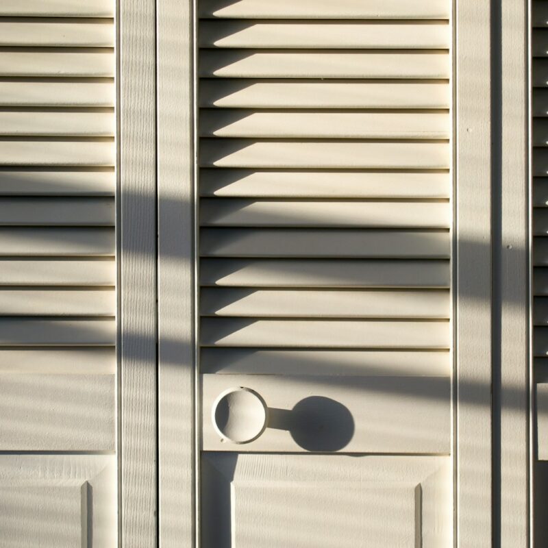 white wooden louver door closed